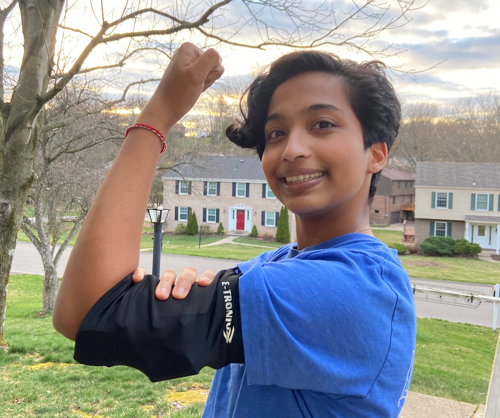 Aditri Thakur shows off the BuzzBand, a wearable fitness device for youth with autism.